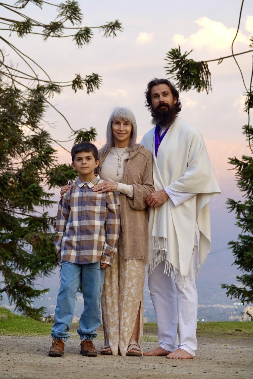 Awe standing with family at dusk, foothills and a lavender sunset sky behind them