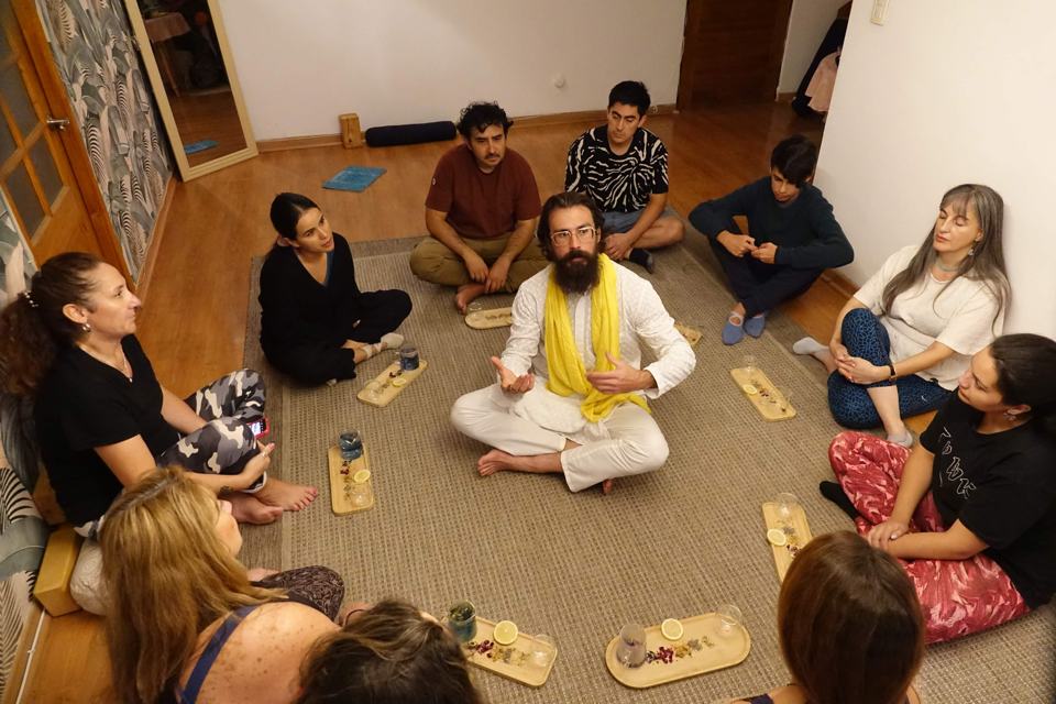 A session circle — people seated on the floor around Awe
